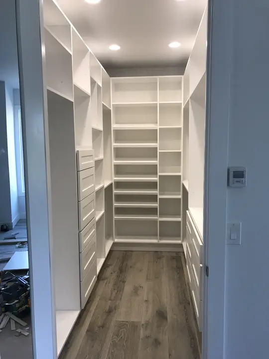 Custom walk-in closet with shelving and drawer towers