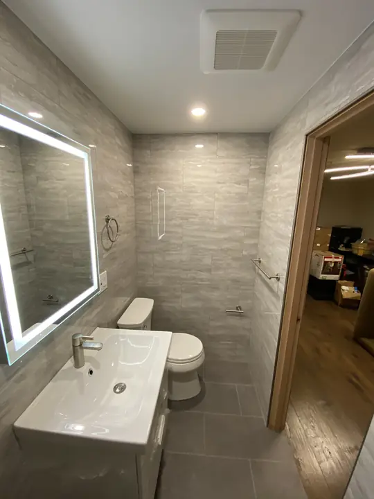 Compact bathroom with LED mirror and floating sink