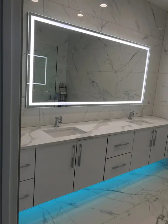 Floating vanity with LED toe-kick lighting and illuminated mirror