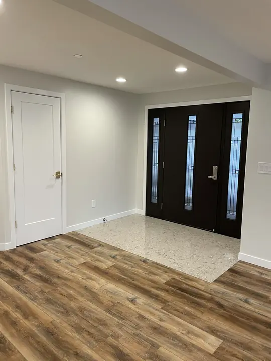 Entry with tile inset and wood-look plank flooring
