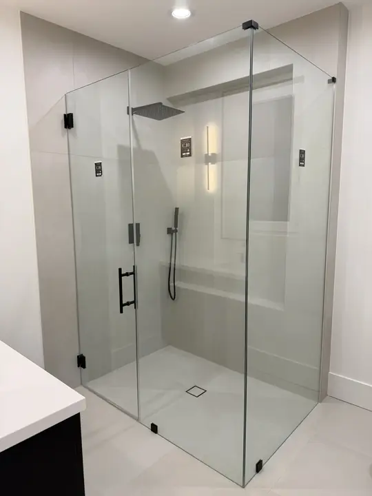 Frameless corner shower with matte black hardware