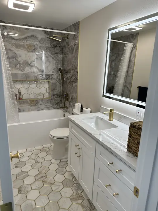 Bathroom with hexagon marble floor, LED mirror and tiled tub