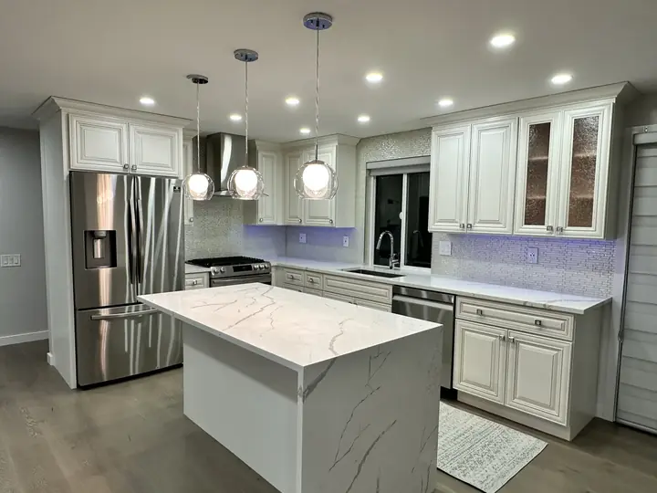 Classic kitchen with marble island and glass pendants