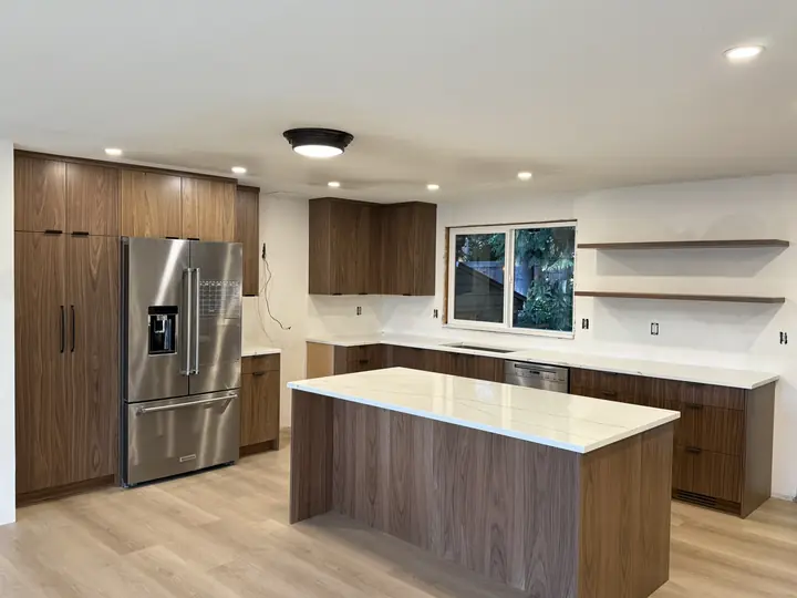 Walnut cabinetry kitchen with quartz-topped island