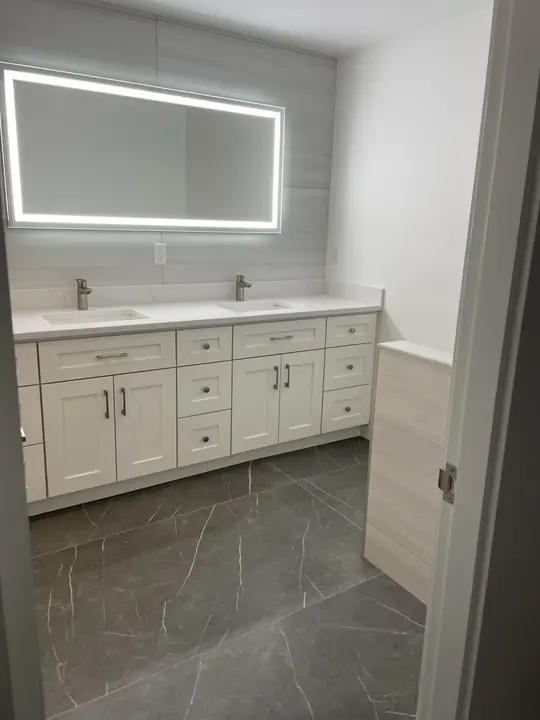 Double vanity under a wide backlit LED mirror