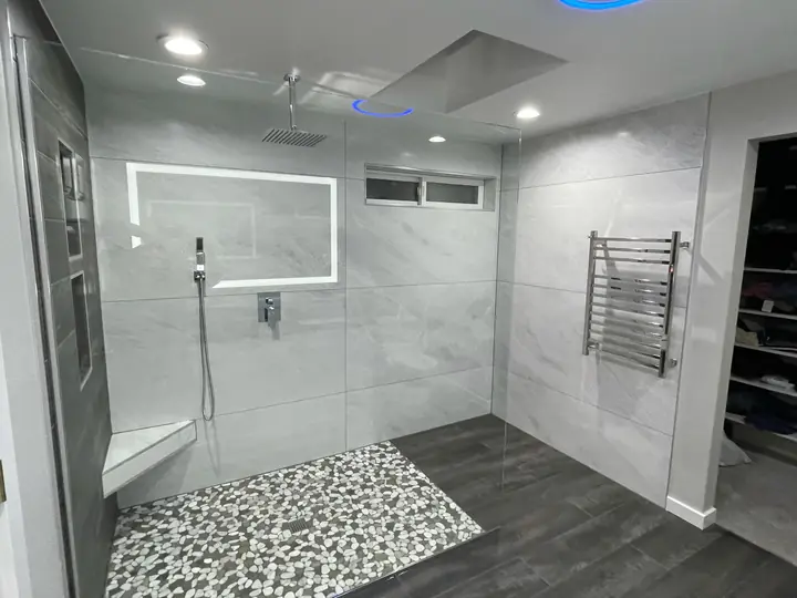 Open shower with lit niche, heated towel rail and skylight