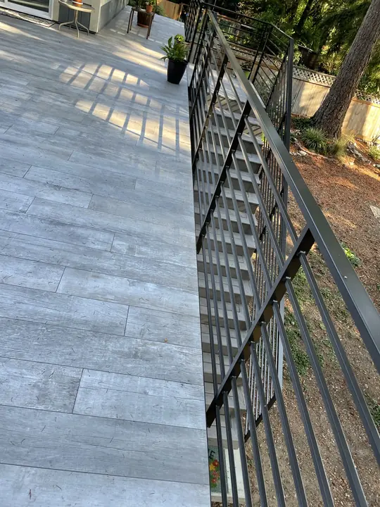 Tiled deck stairs with steel railing