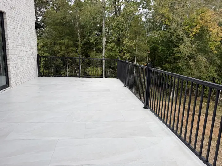 White porcelain terrace with black aluminum railing