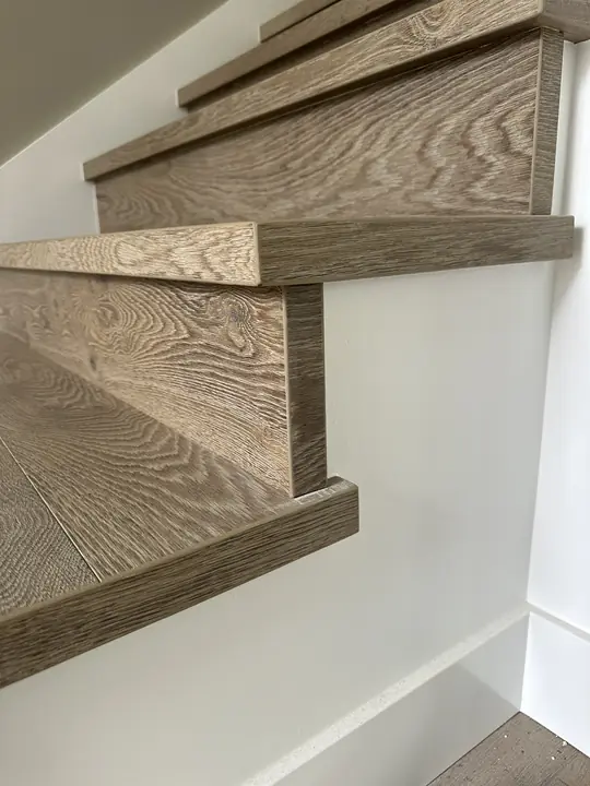 Close-up of a precisely fitted stair tread and riser